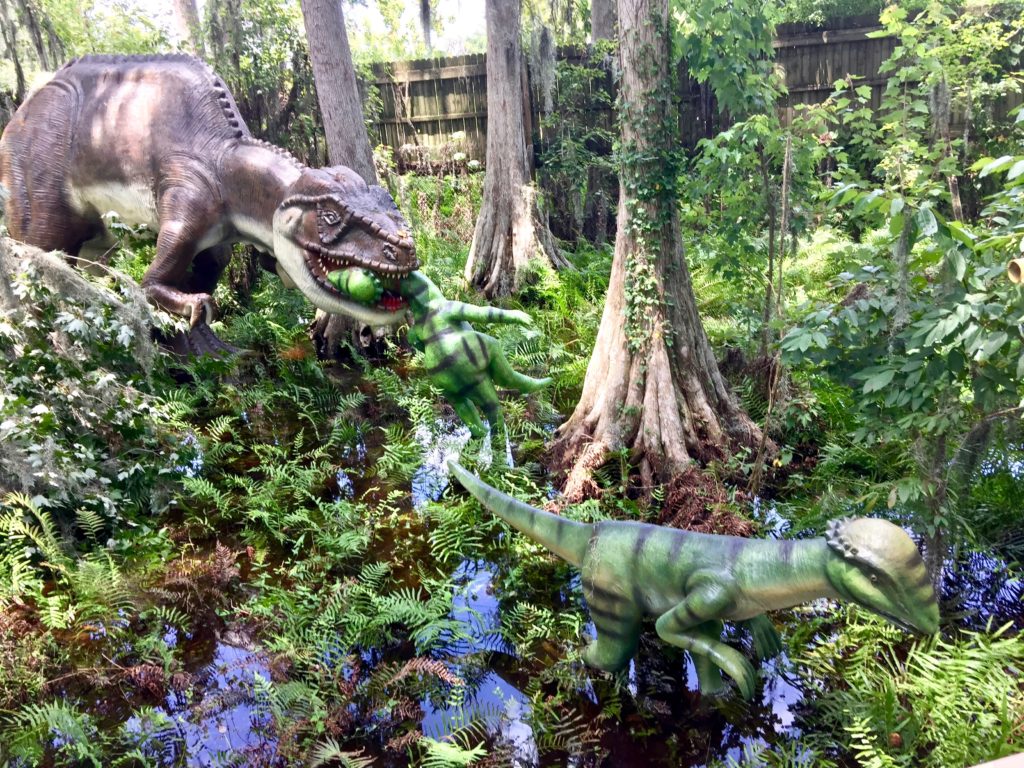 dinosaur eating dinosaur - wide shot
