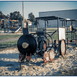 An old playground with a metal bar train