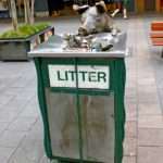 Bronze pig sculpture rooting through litter