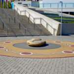 Rock surrounded by circular paintings